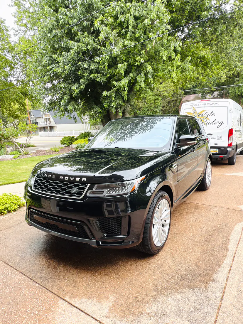 Black Range Rover Sport after an exterior detail, the Lifestyle Detailing van parked behind it