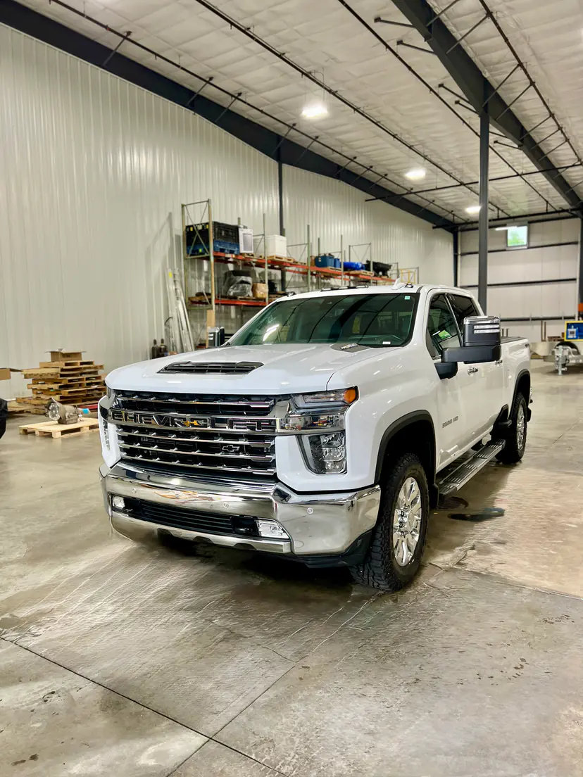 White Chevrolet Silverado 2500 HD after a detail inside a steel pole barn in Cascade Township, Michigan