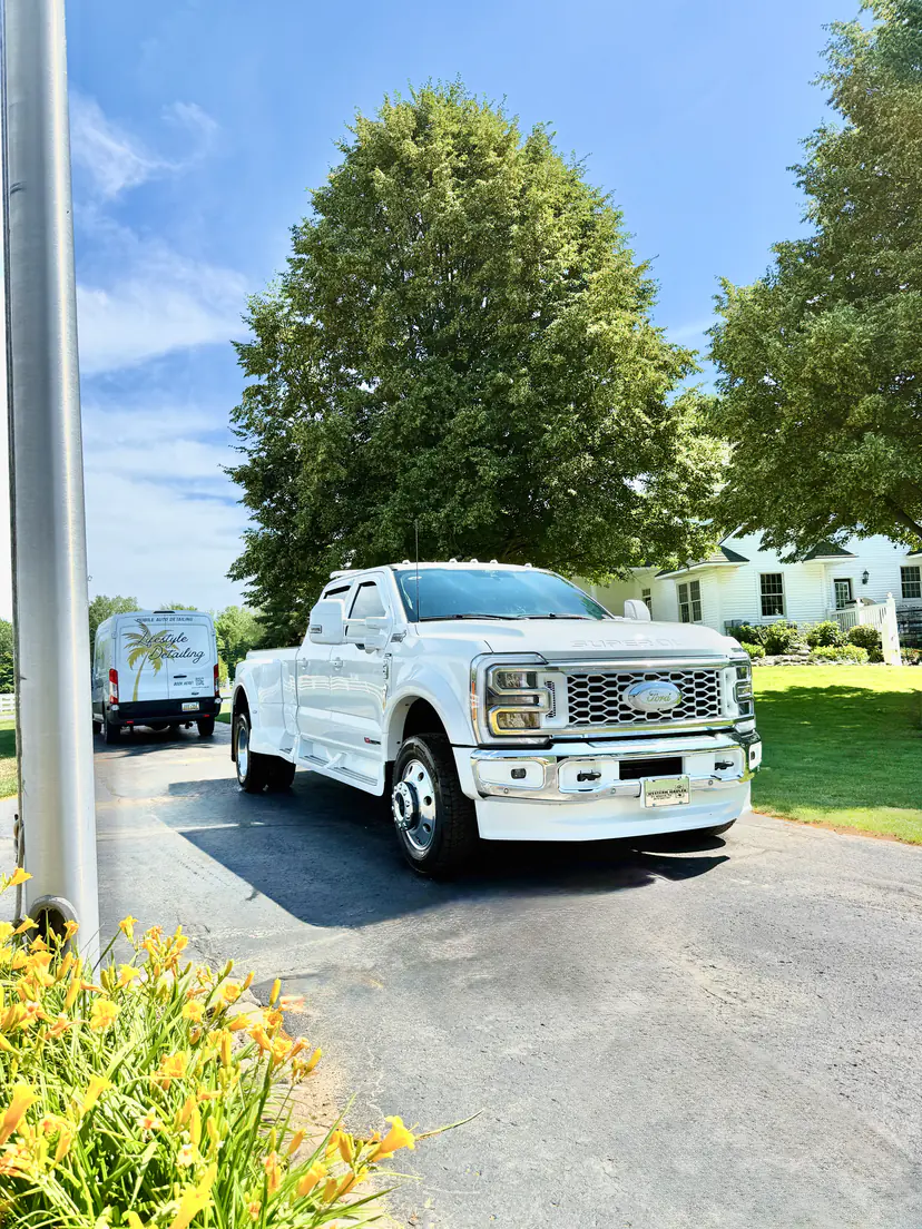 White Ford F-450 Super Duty after a detail, the Lifestyle Detailing van at the end of the drive
