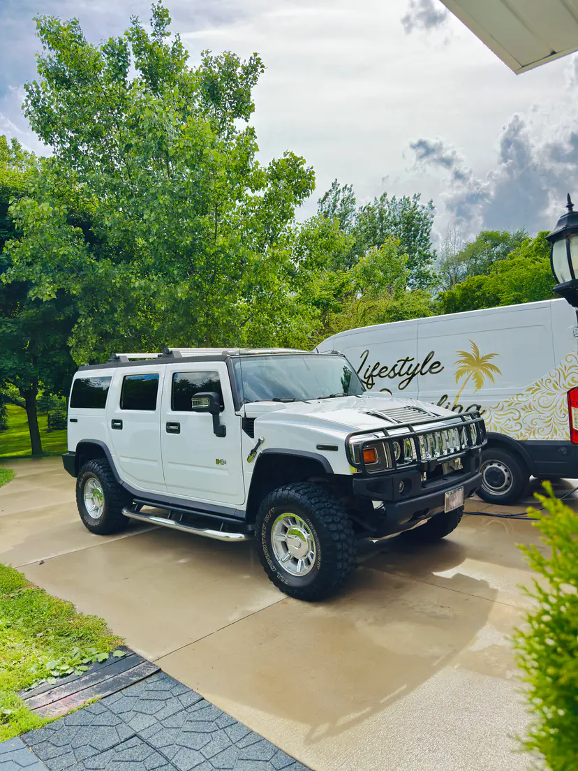 White Hummer H2 after an exterior detail beside the Lifestyle Detailing van