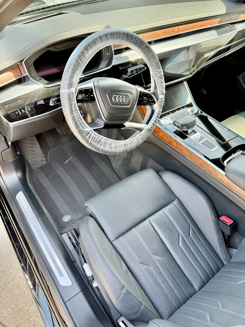 Audi A8 L front cabin with spotless leather and walnut trim after an interior detail