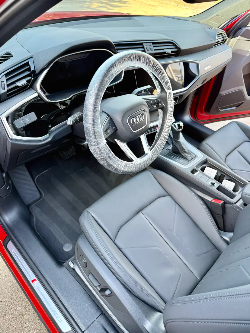 Audi Q3 front cabin with clean leather seats and fresh carpet lines after an interior detail