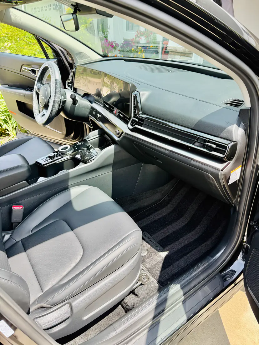 Kia Sportage front seats and dash after a mobile interior detail, fresh vacuum lines in the mats