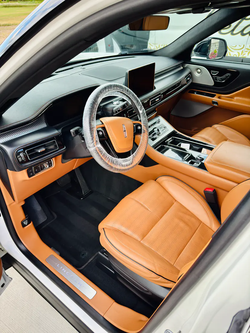 Lincoln Aviator interior with cognac leather seats and clean carpets after an interior detail