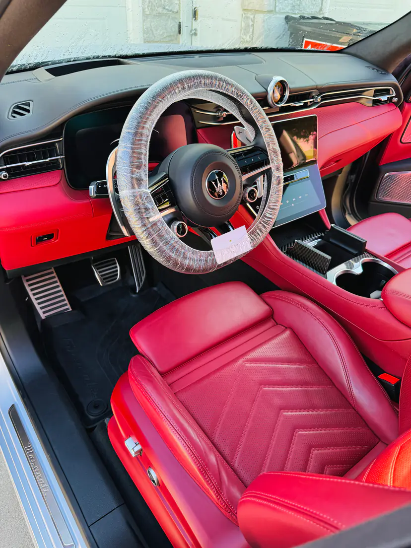 Maserati interior with red leather seats cleaned and conditioned during an interior detail