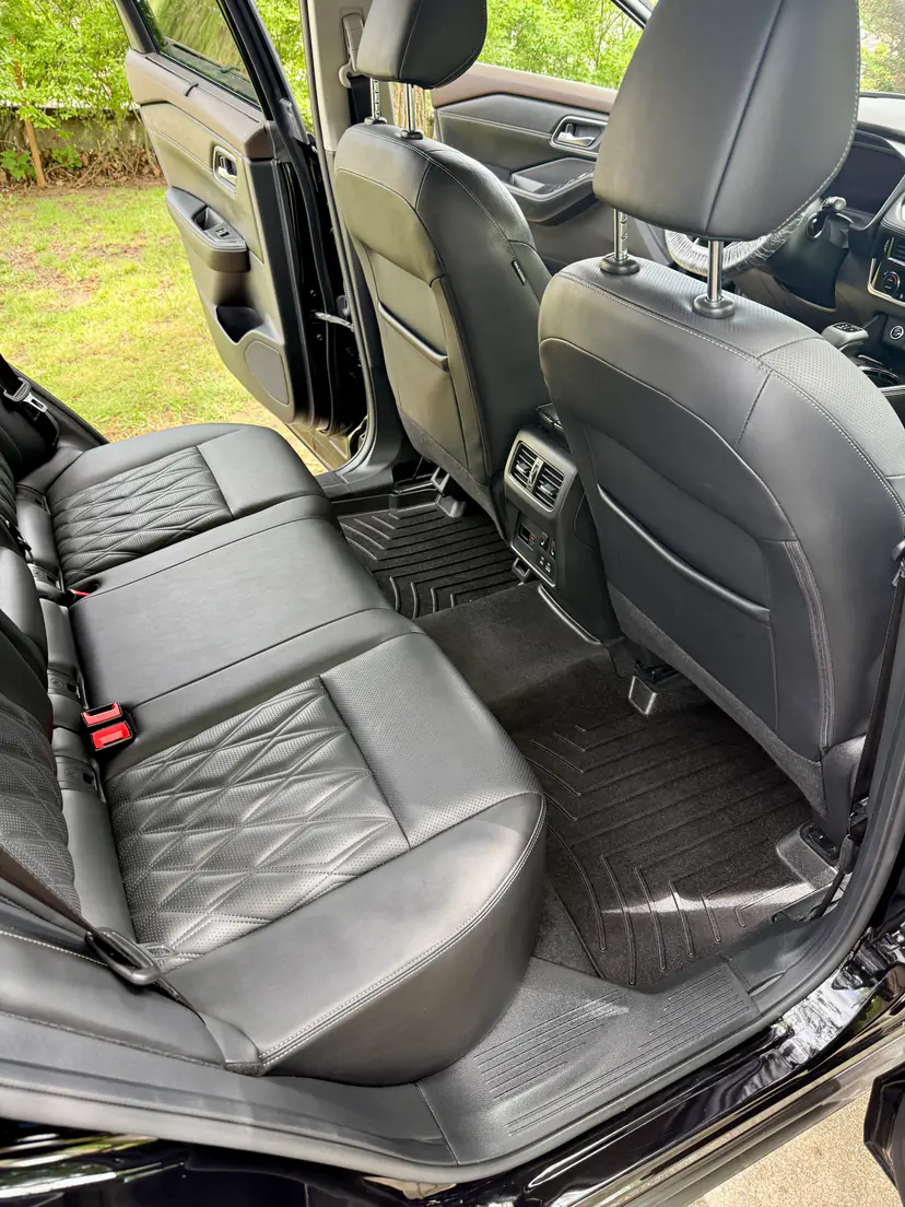 Nissan rear seat in quilted black leather after a mobile interior detail in Grandville, Michigan