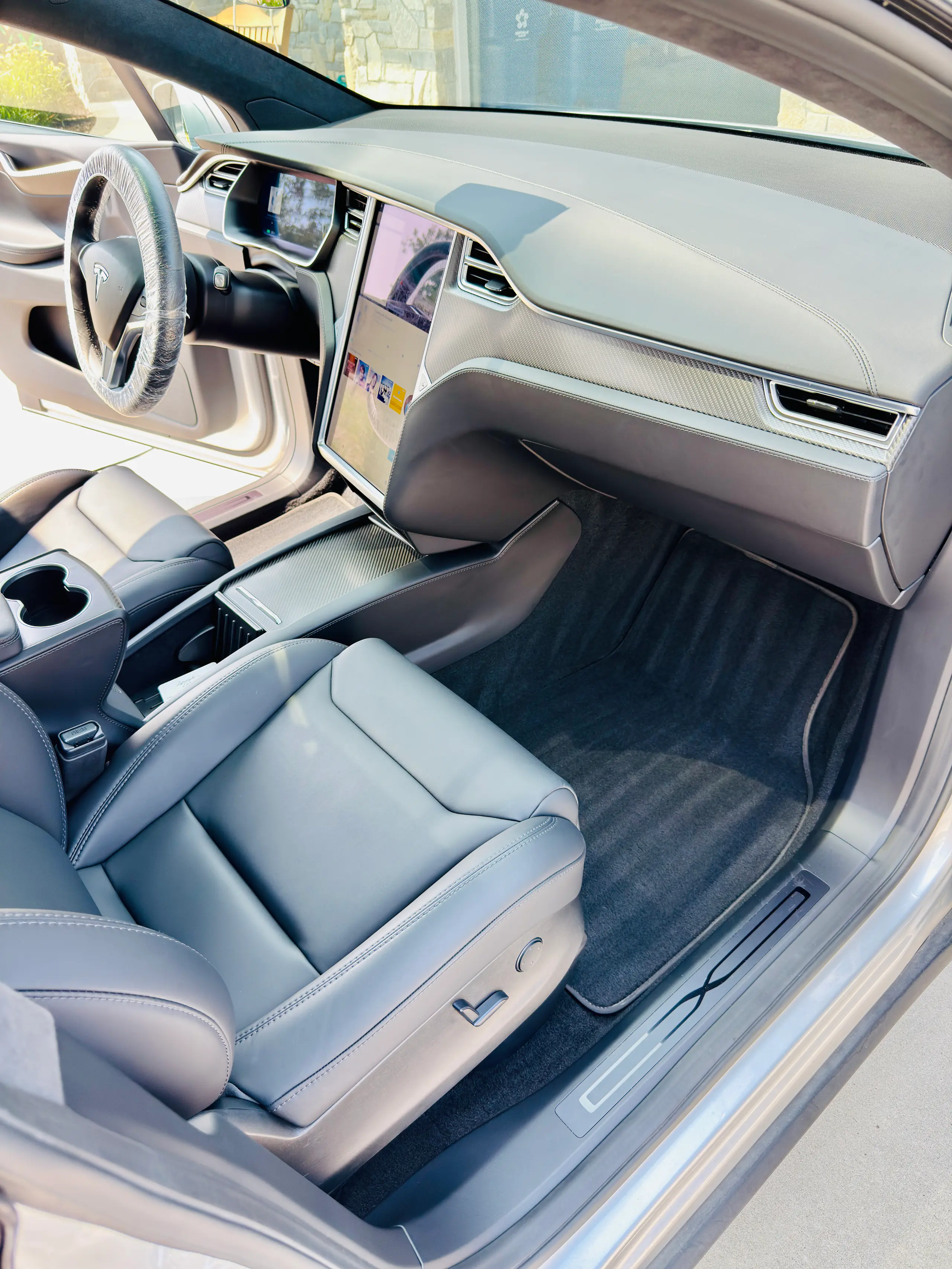 Clean white leather seats and center console in a Tesla Model X after an interior detail