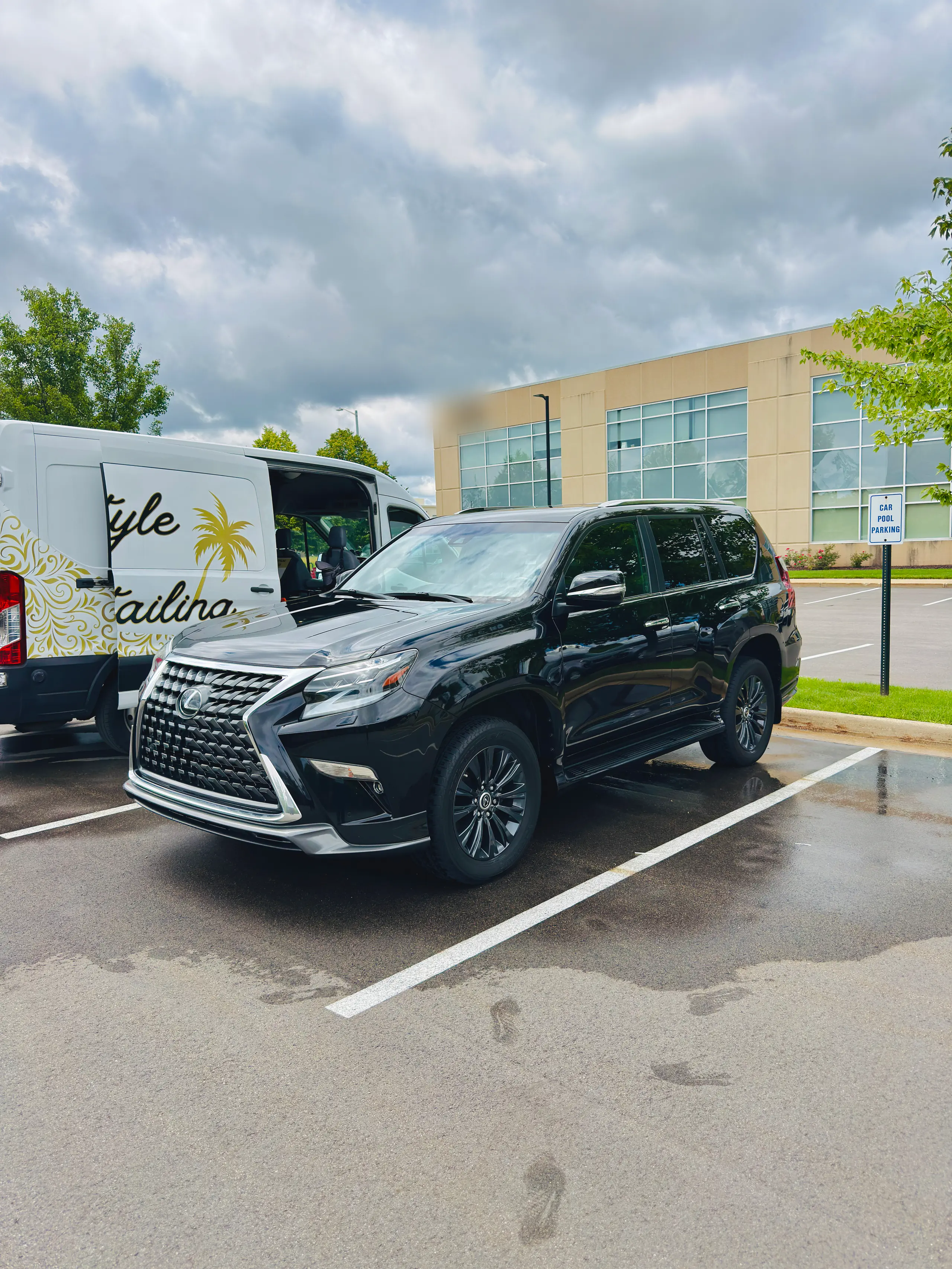 Lexus GX detailed in an office parking lot beside the Lifestyle Detailing van, without leaving work