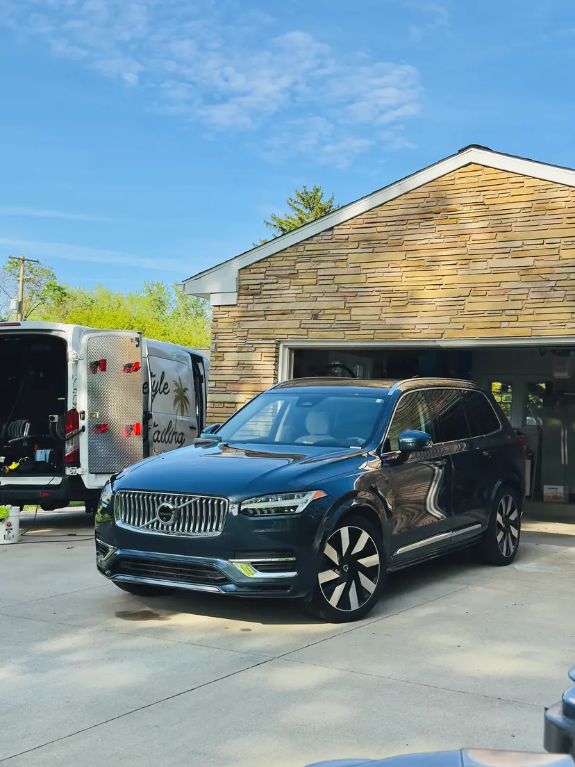 Volvo XC90 in a customer's driveway in Grand Rapids Township, Michigan, beside the open Lifestyle Detailing van and its mobile setup